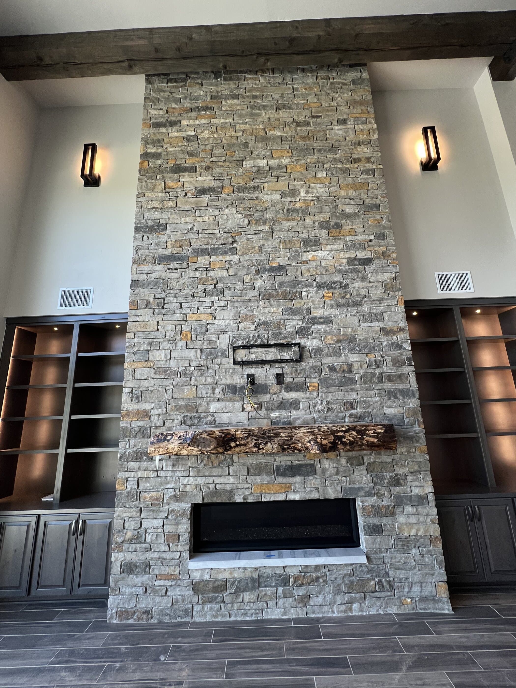 Stone fireplace with live-edge wood mantle