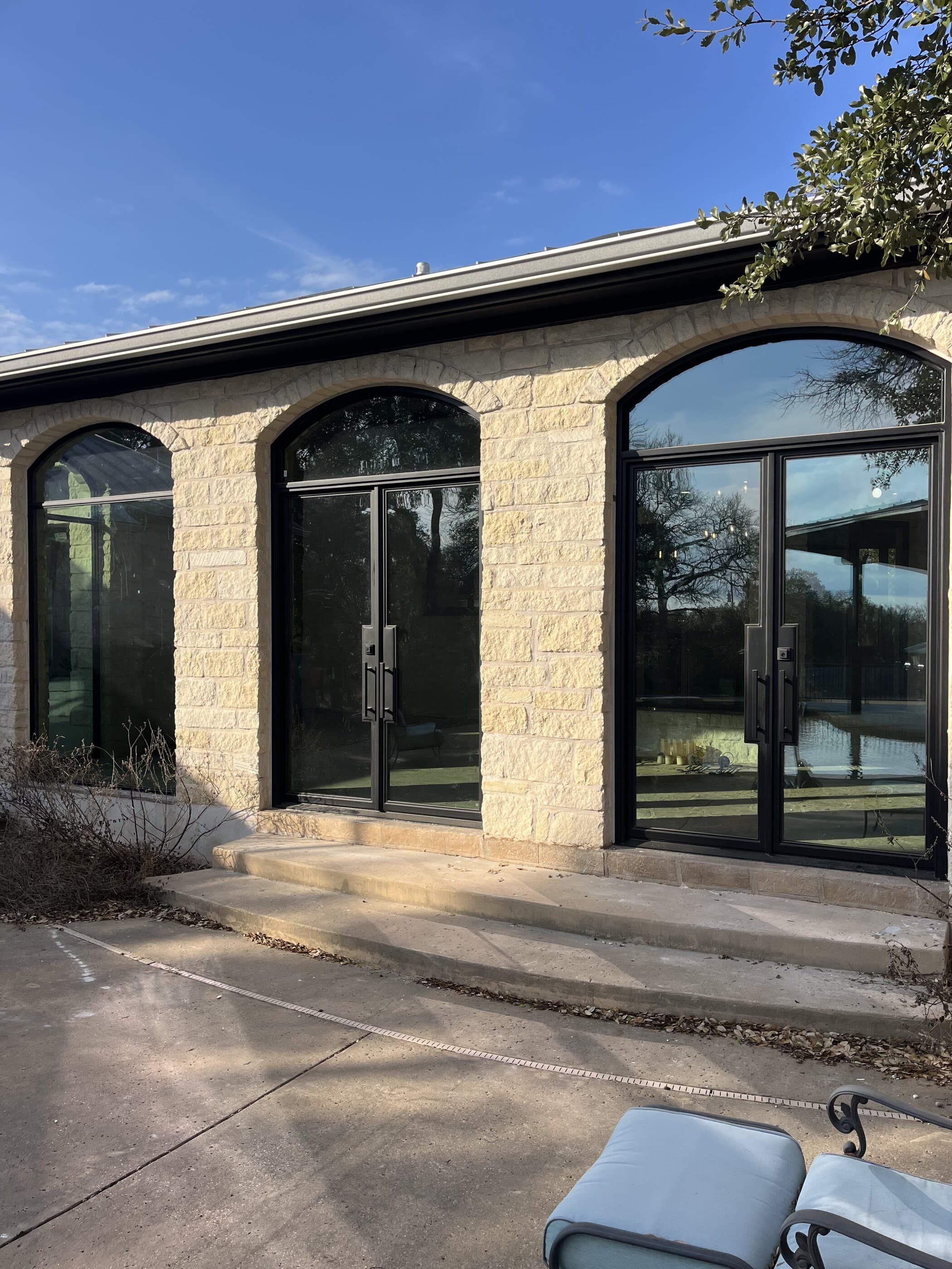 Arched entry doors with pool reflection